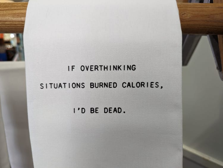 Sign reading "If overthinking situations burned calories, I'd be dead." Wait, human breathing releases CO2!