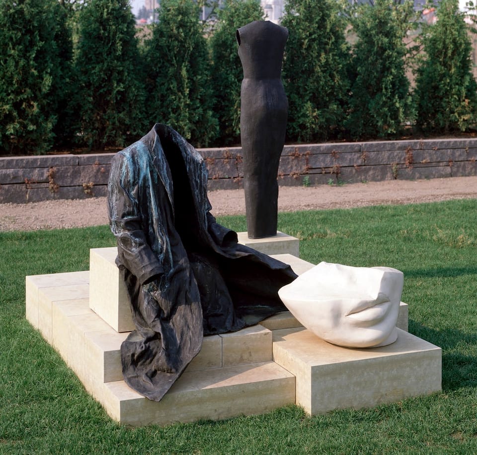 Without Words sculpture by Judith Shea showing an empty coat, half a head, and an armless torso