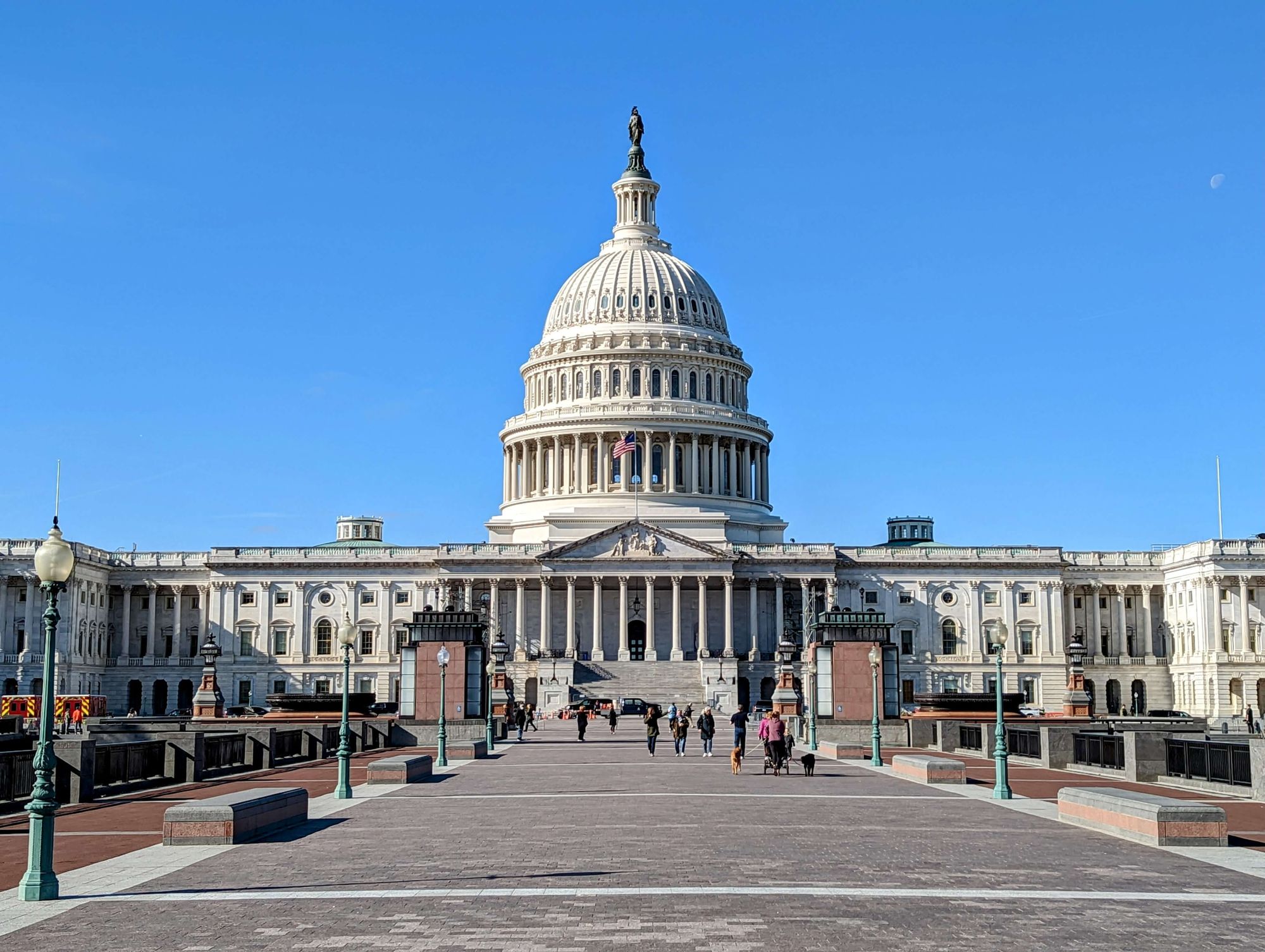 Head on view of US Capitol Building in Washington, DC with blue sky background