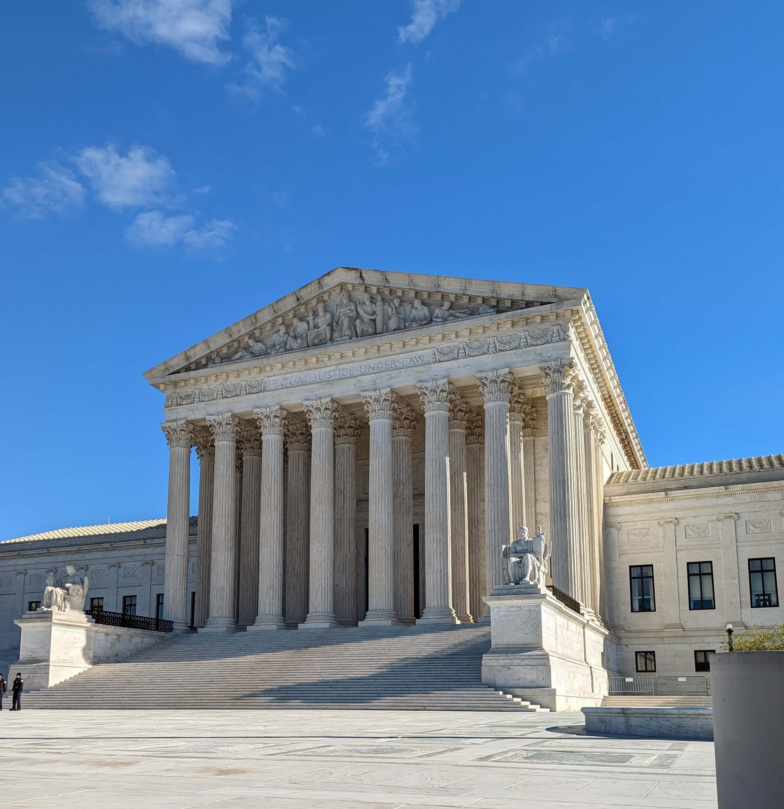 Slightly offset view of US Supreme Court in Washington, DC with blue sky background