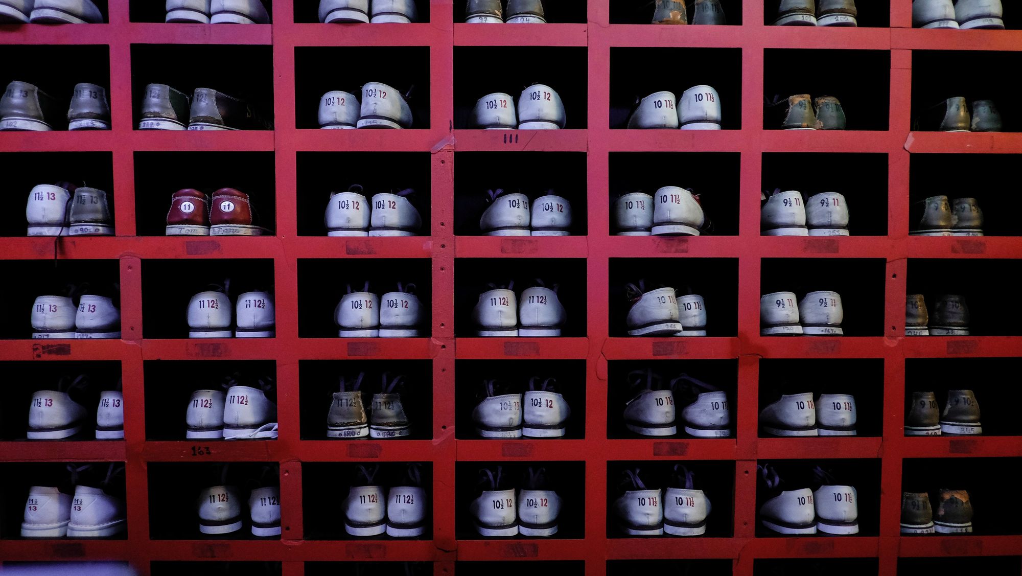 Bowling shoes in individual cubbyholes