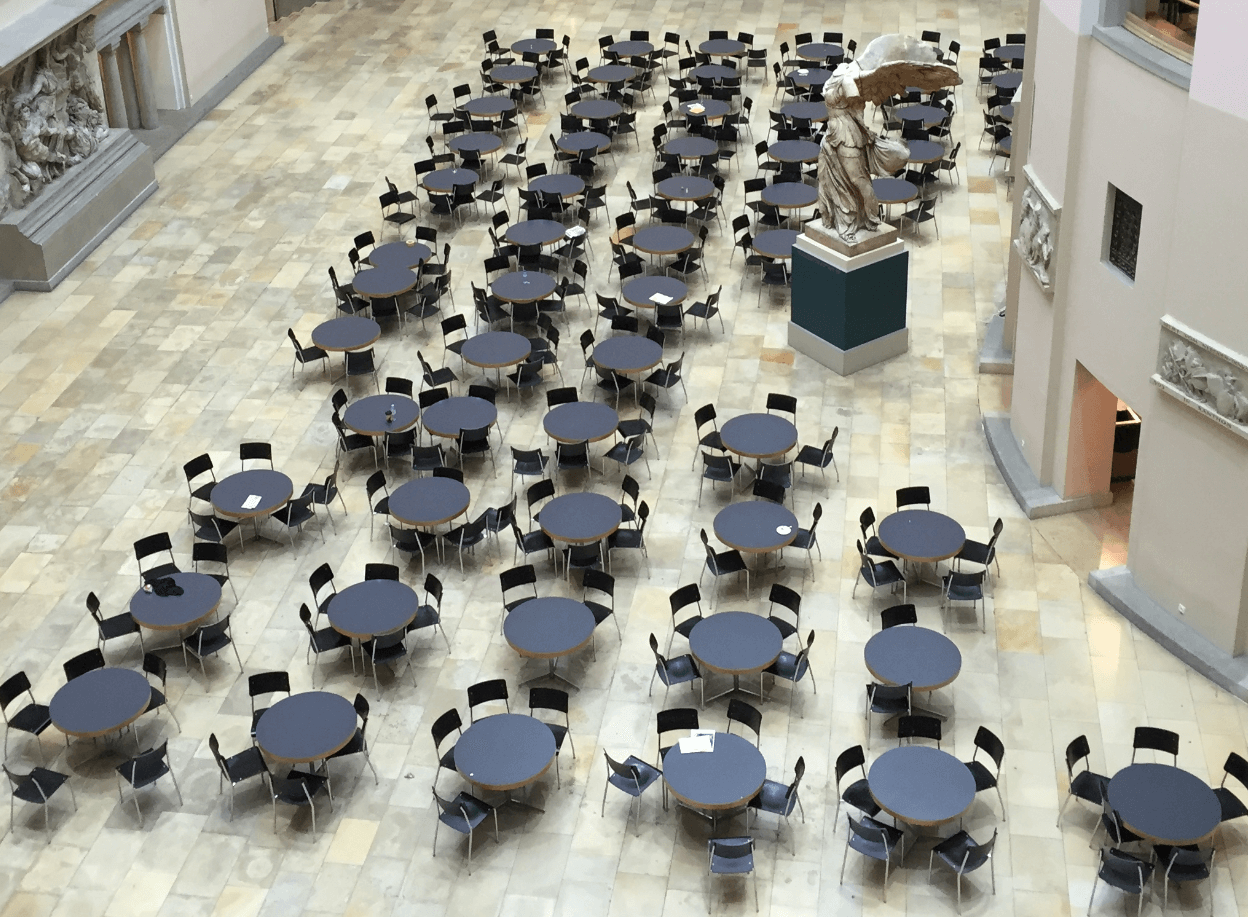 Many black round tables with black chairs