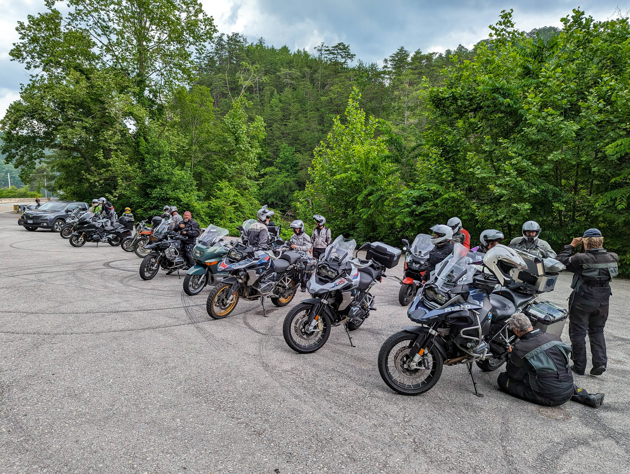 Row of BMW adventure bikes with riders in gear