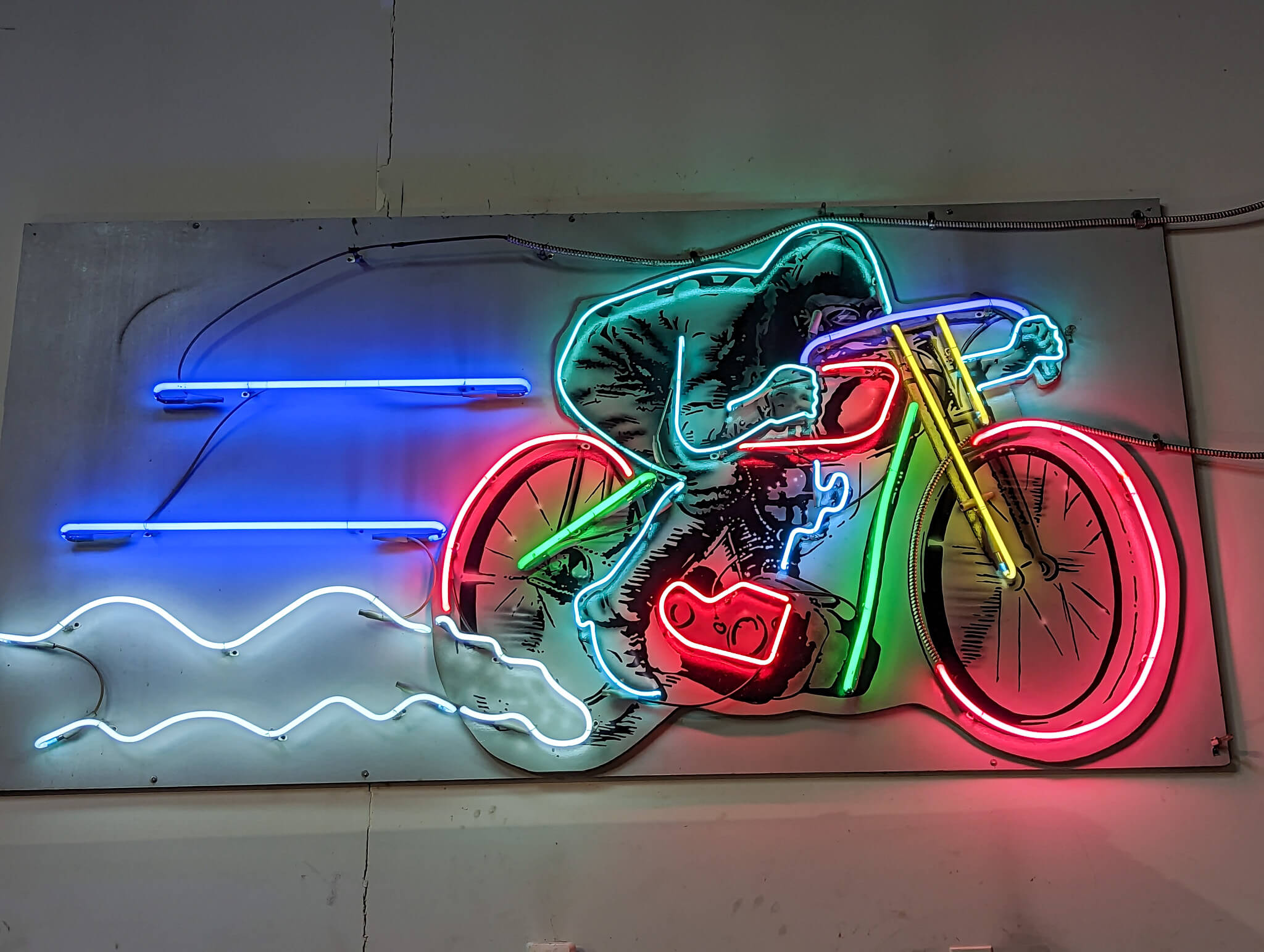 Neon sign of a cafe racer riding fast