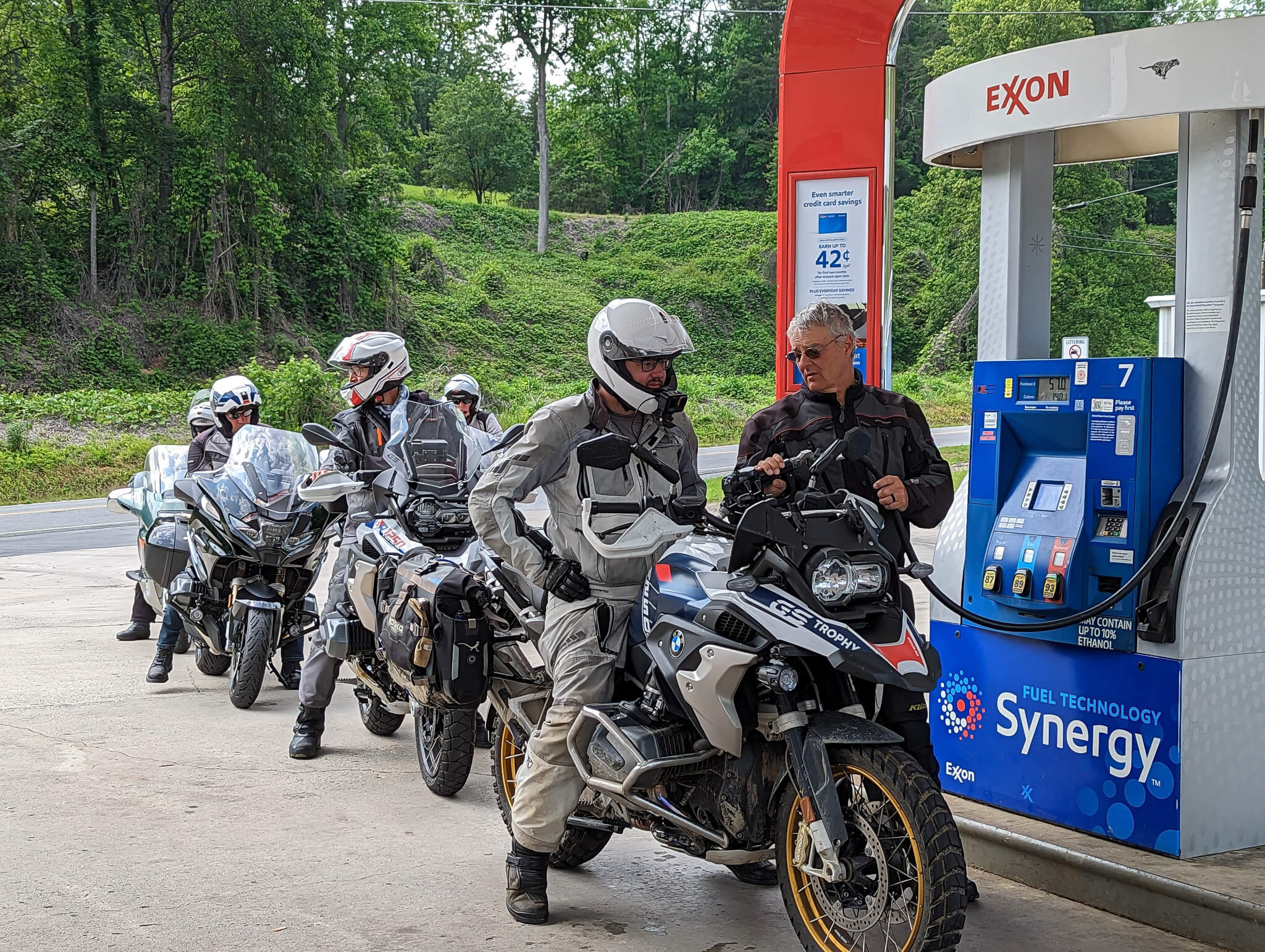 Row of motorcyclists lined up to get gas