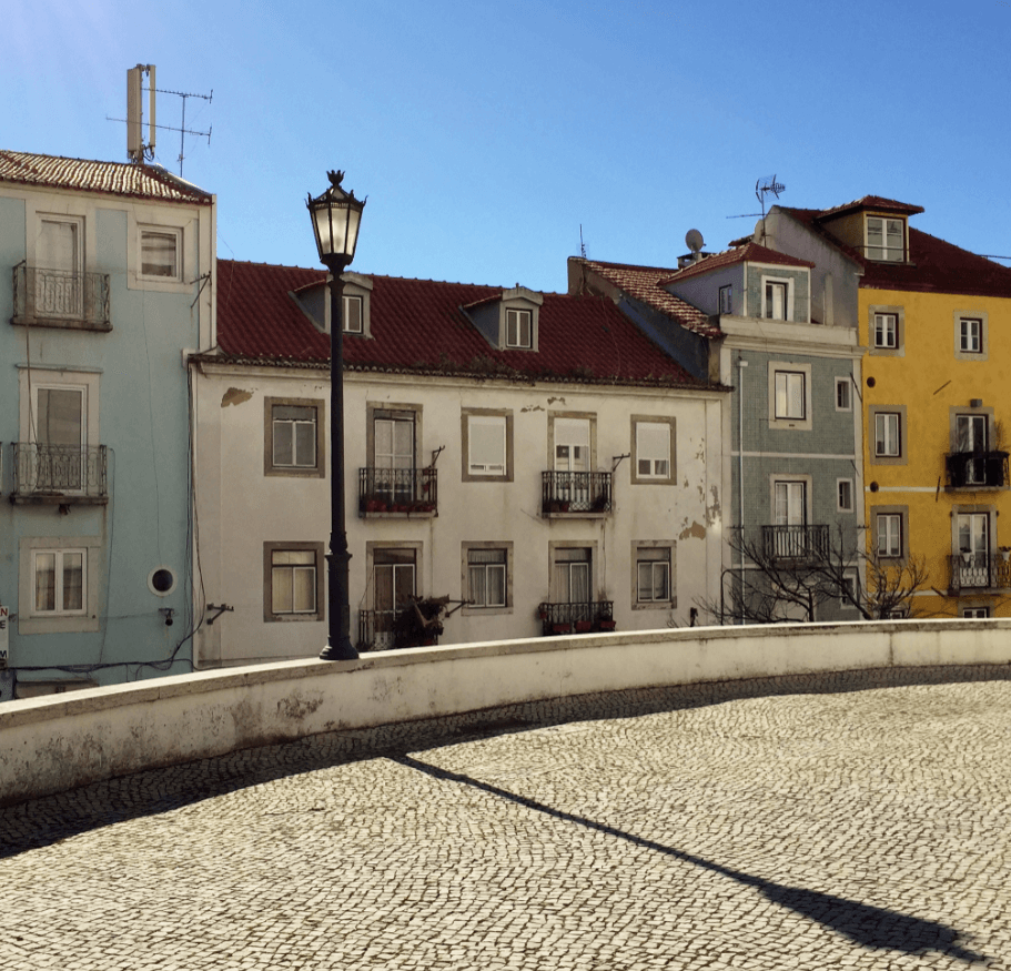 Cobblestone street fronting a row of Mediterranean-style stone houses