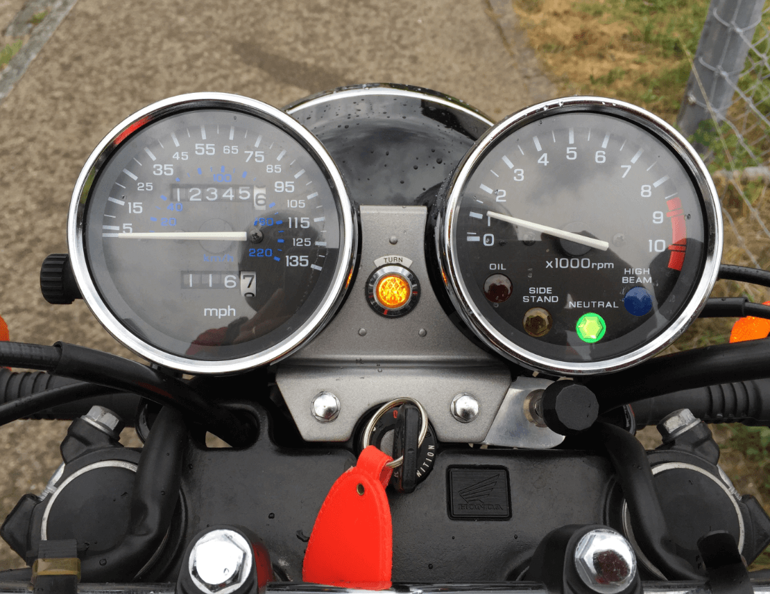 Motorcycle instrument panel showing analog gauges