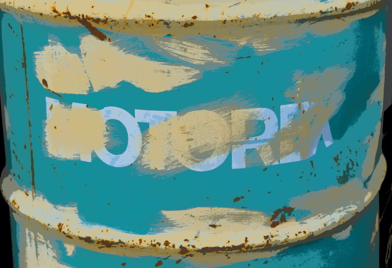 Metal barrel with smudged paint and word MOTOREX