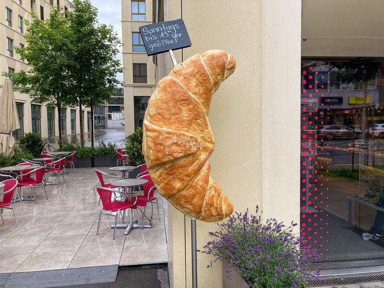 Gigantic croissant outside a bakery