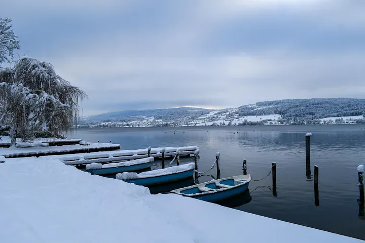 The Lake Greifensee in Zurich - rowboats covered in snow