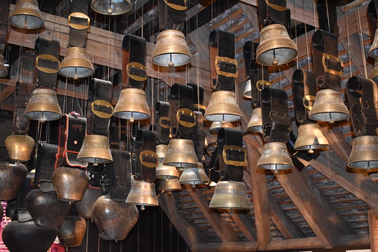 Many brass cowbells hanging from the rafters of a barn. Don't get me started on our cows and chocolate
