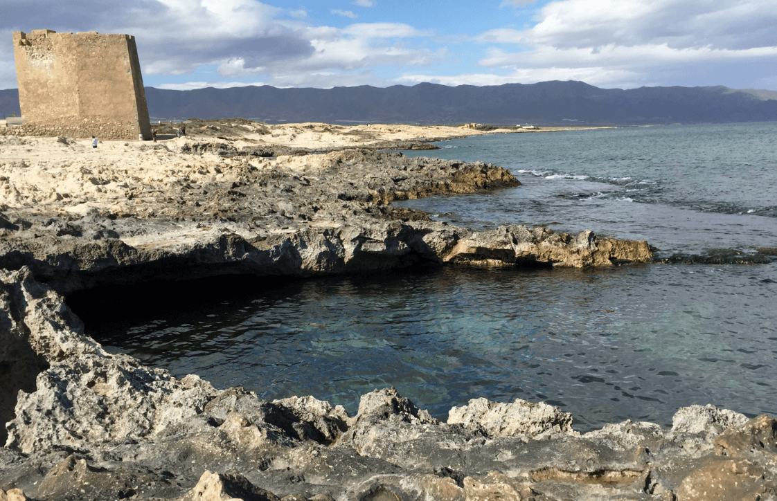 Rocky coastline with mountains in background - Moral Letters to Lucilius