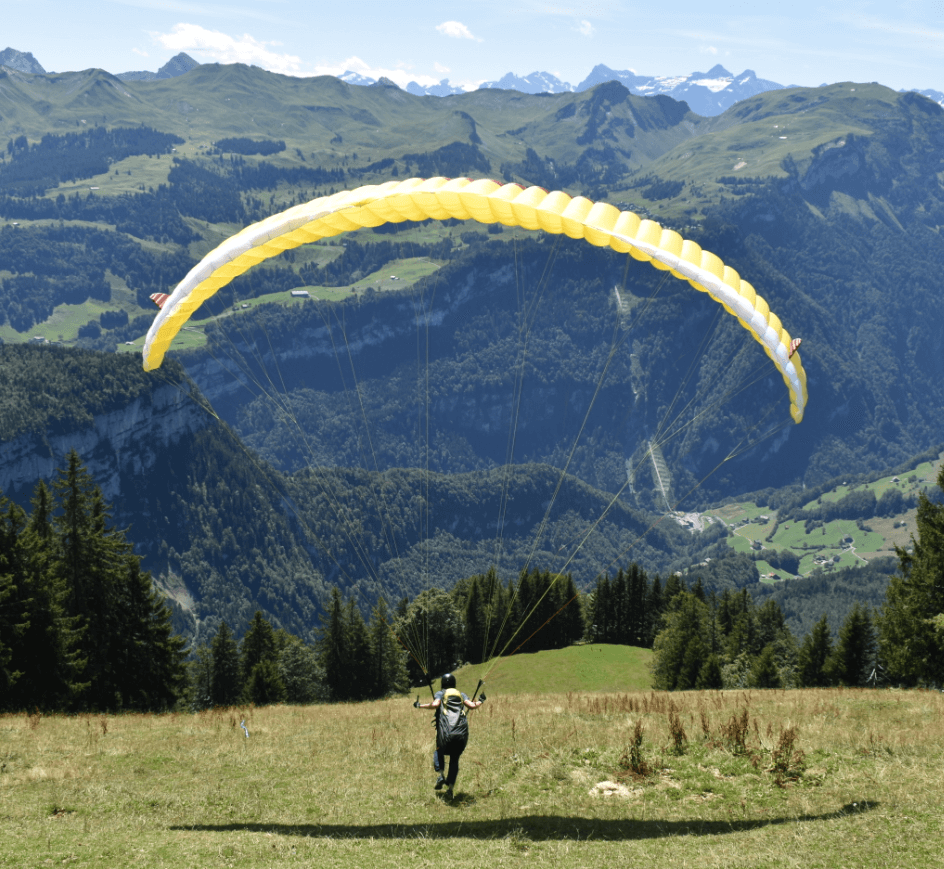 Mountain view with a paraglider taking off in the foreground - Moral Letters to Lucilius