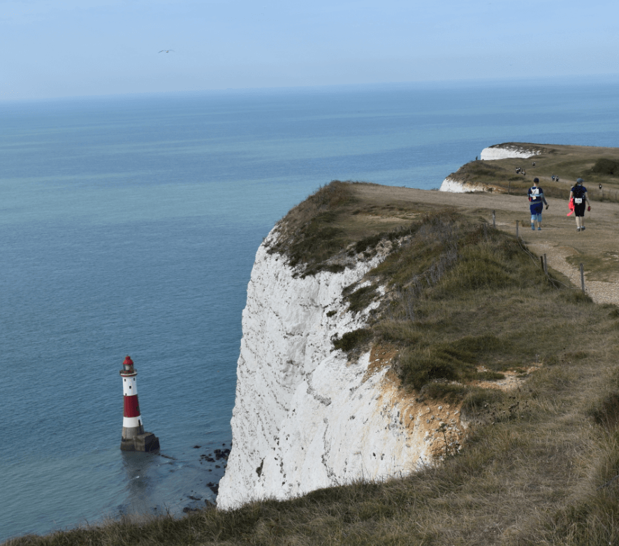 Steep chalky cliff before a lighthouse in the water - Moral Letters to Lucilius