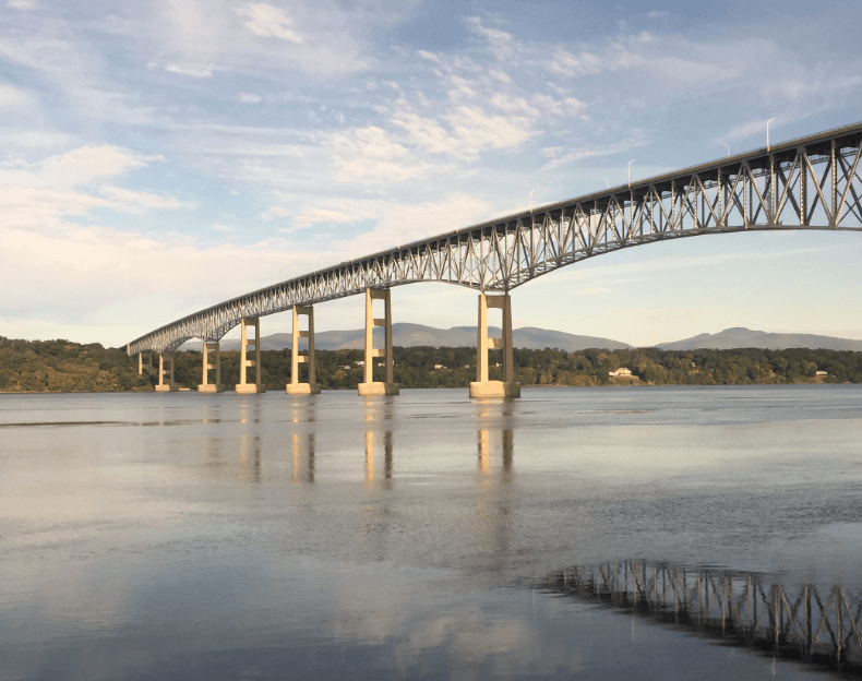 A long trestle bridge crossing a wide river