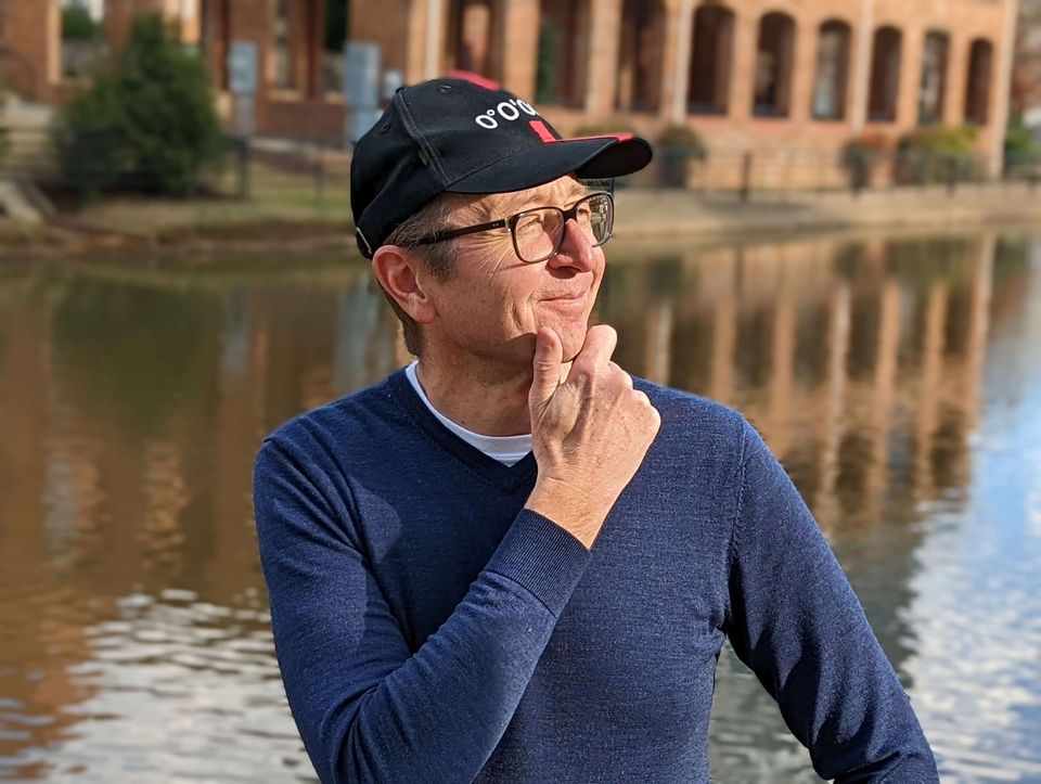 Man in profile holding his chin contemplatively