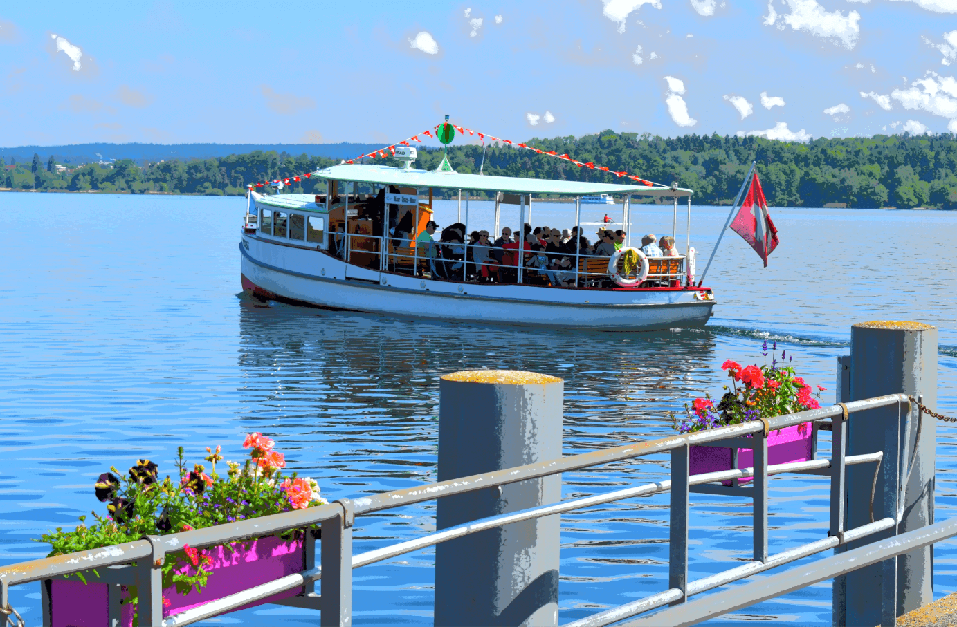 Small steamship with passengers on tranquil lake