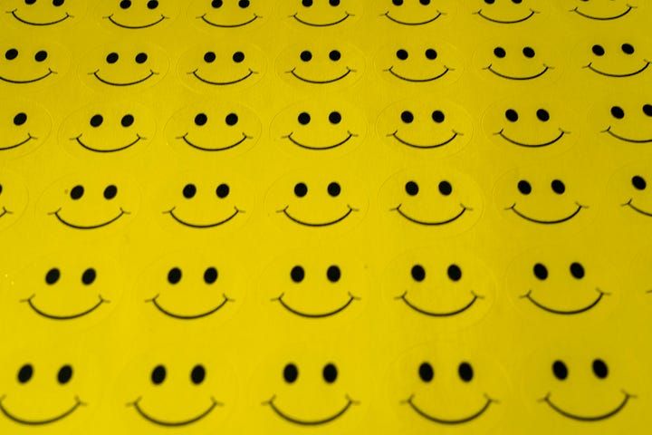 Row upon row of smiley faces on yellow background