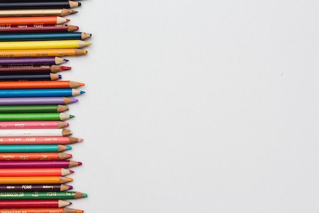 A row of colored pencils with the tips all at different lengths