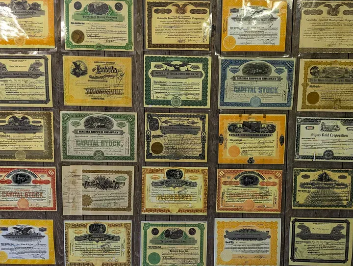 Wall of stock certificates of defunct corporations